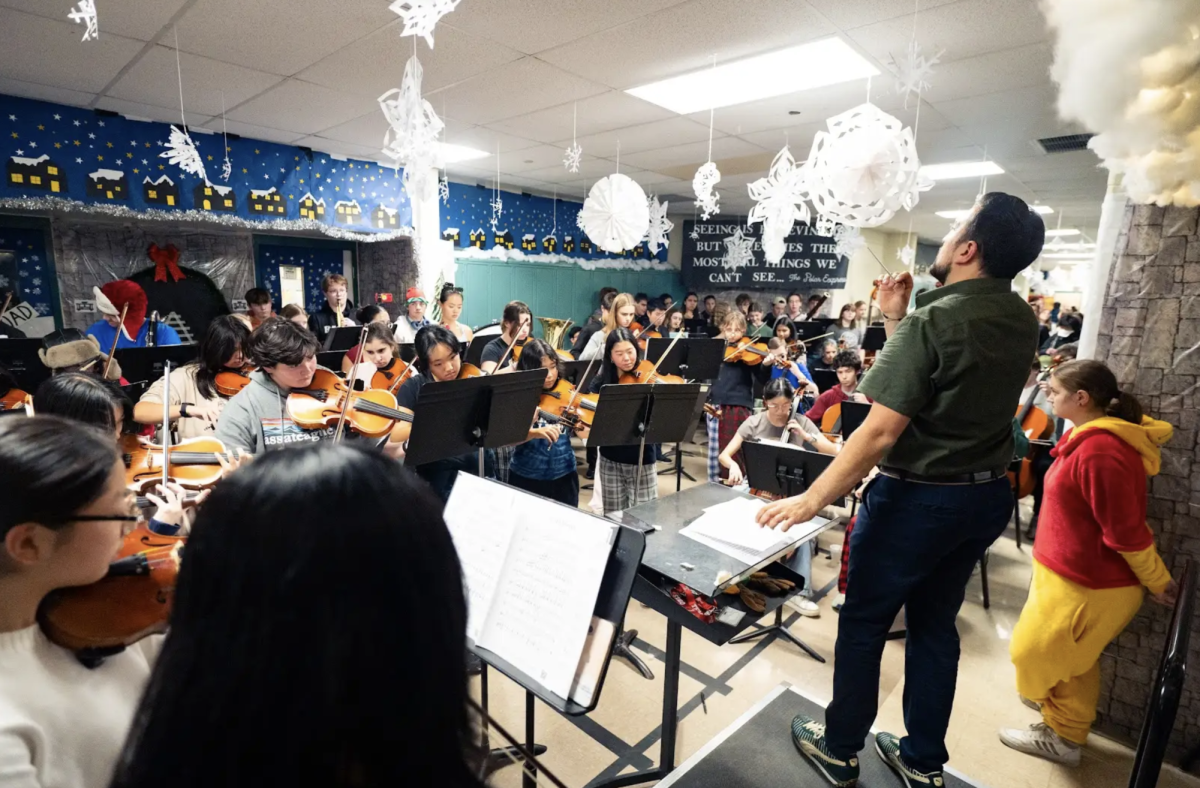 Orchestra conductor Mr. Nick Pignataro conducts the annual winter orchestra hallway concert on December 9. There was multiple weeks of preparation for this event, from the 2nd floor hallway classes participation in decorations, to the table stacked with hot chocolates.