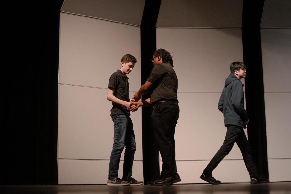 Senior Nick Bisordi shakes technical theater adviser Mr. Johnathan Hardy's hand after recieving an award.
