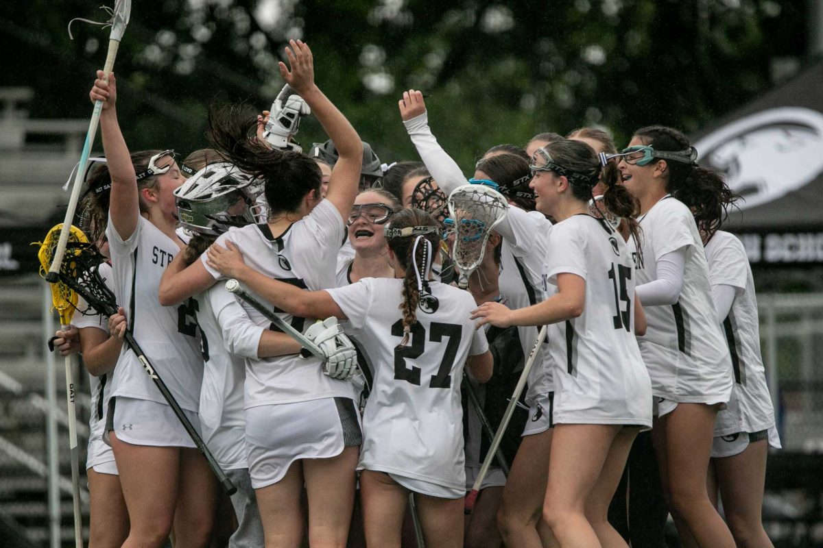 The varsity girls lacrosse team celebrates with a team huddle after winning their semifinal match on May 22, securing them a spot in district 1 finals. "I think we came out with super-high intensity, wanting to perform better for the girl next to us and for our team," Kat Hamilton (10) said. "Even if you're not feeling a hundred percent, you just want to do it for your team."