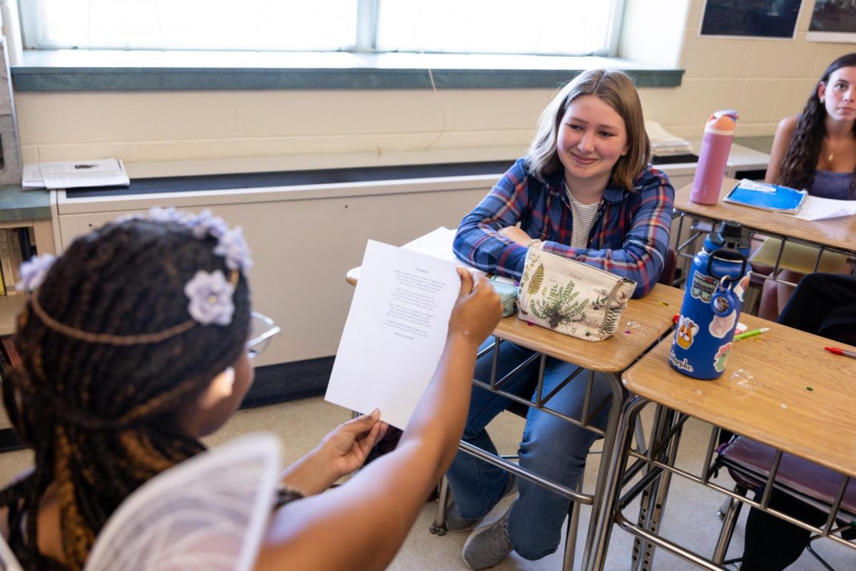 Senior Annika Grant shares looks of embarrassment as she receives a sonnet from freshman Dylan Blake during Sonnetpalooza on Monday April 28. 