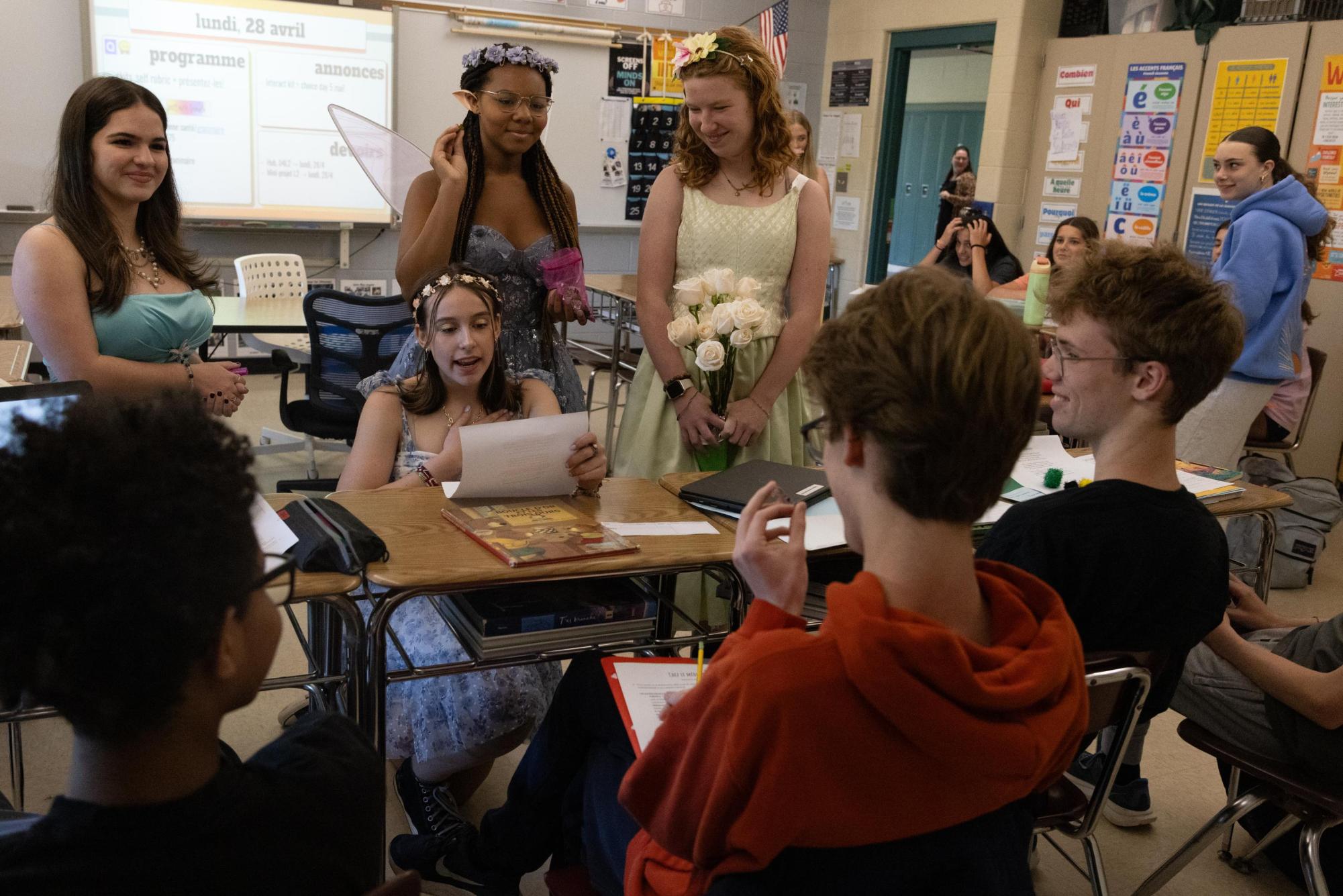 Freshman Scarlett Rein reads a custom sonnet during Sonnetpalooza on Monday April 28. Jabberwocky members sold sonnets as a fundraiser for the publication. Members delivered the sonnets with kazoos, confetti, and bubbles, to recipients during class