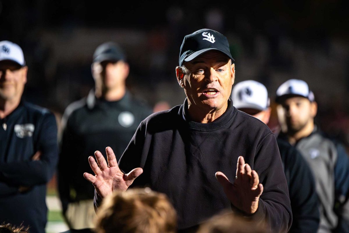 Health and Physical Education teacher and football head coach Mr. Kevin Clancy addresses the football team after their 14-35 loss against Springfield on October 25. Clancy will step down from teaching but will continue to coach the football team.