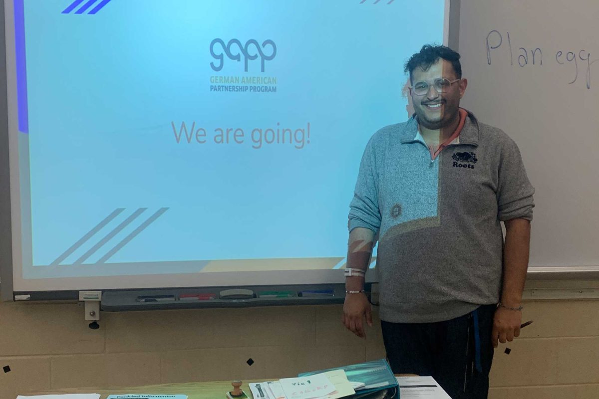 Herr Paul presents on the German exchange during a meeting.