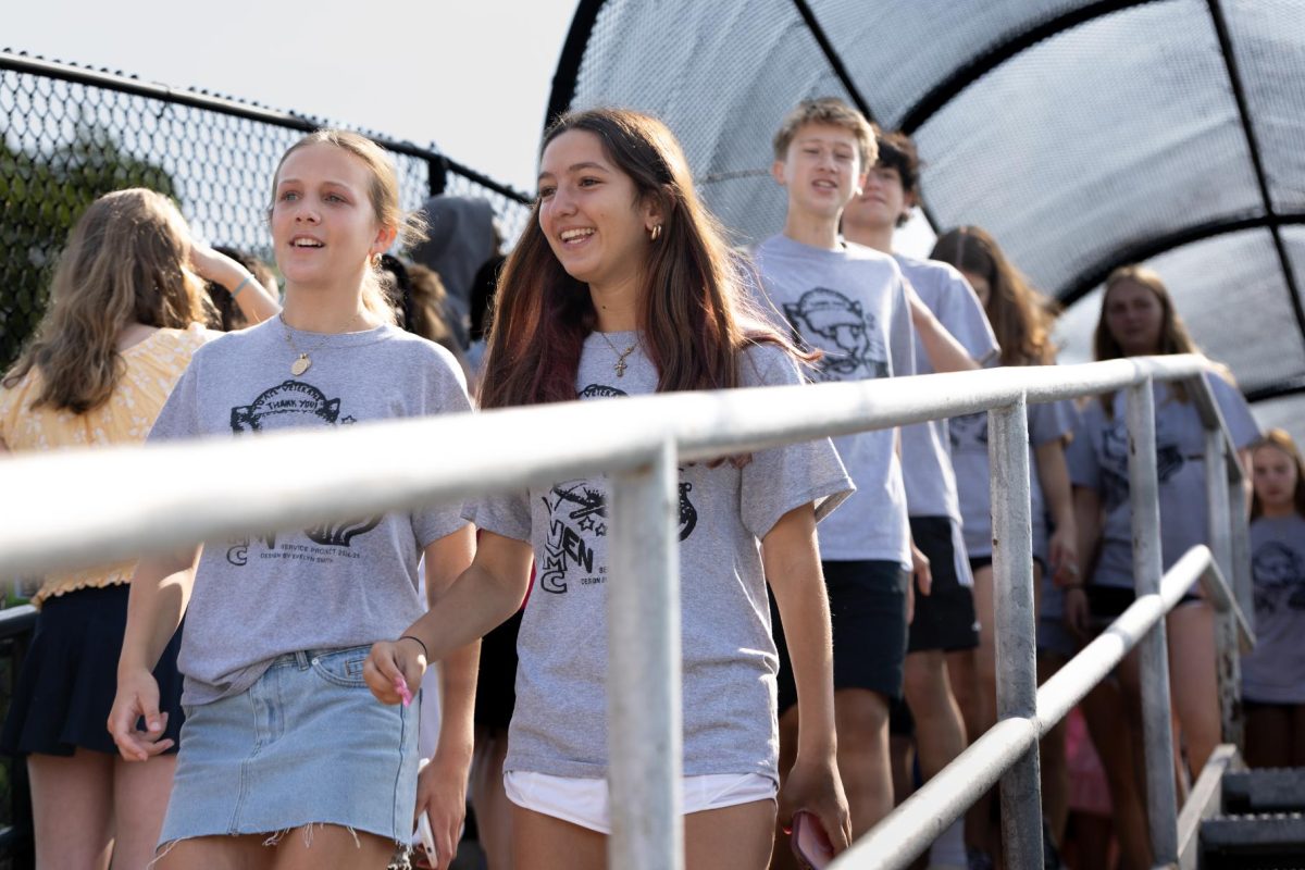 Incoming freshmen Meghan Kelly and Goita Lina Andriopoulos walk the final steps across the bridge, completing their journey to the high school.