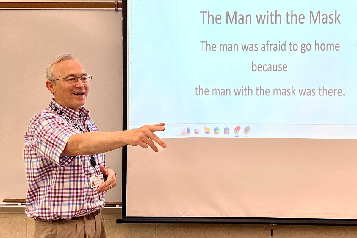 Science teacher Mr. John Lincke excitedly calls on a student during a Friday brain teaser day.