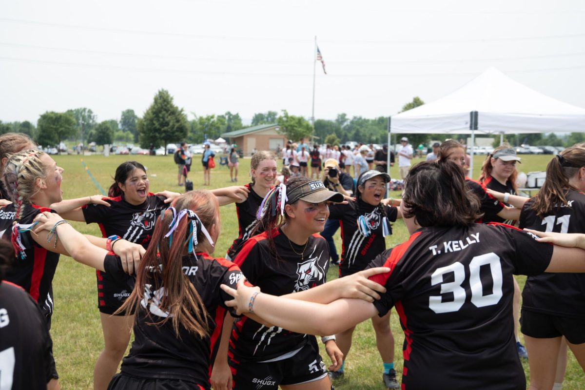 The team has a huddle during a timeout, doing a morale-boosting routine led by senior team captains Lily Hodges and Katie Stack at the HSNI national tournament, June 13, 2025.