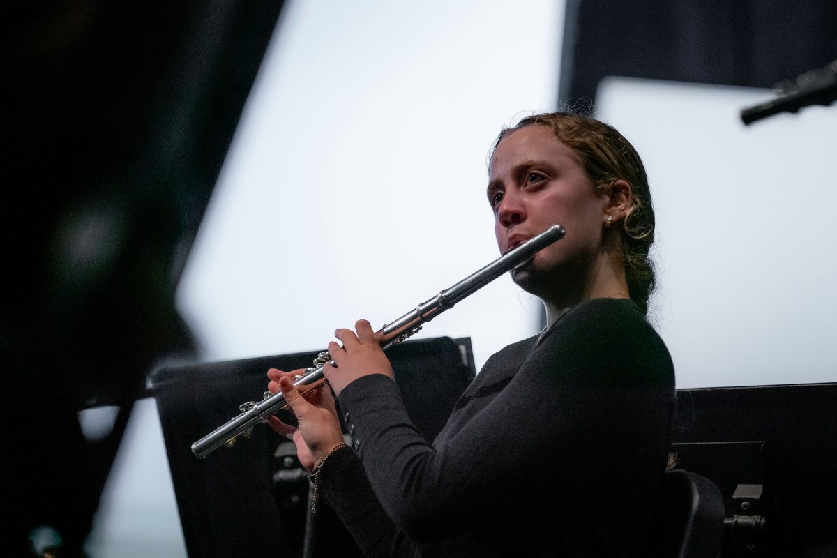 Junior Lexi Benzing plays the flute during the band and orchestra concert on May 14.