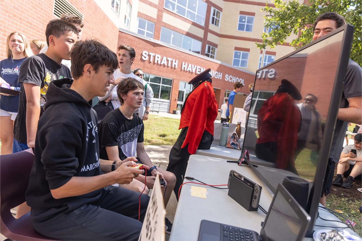 Students play a video game at the E-Sports club booth at the activities fair on Friday, September 5. The fair allowed clubs to recruit new members at the start of the school year.