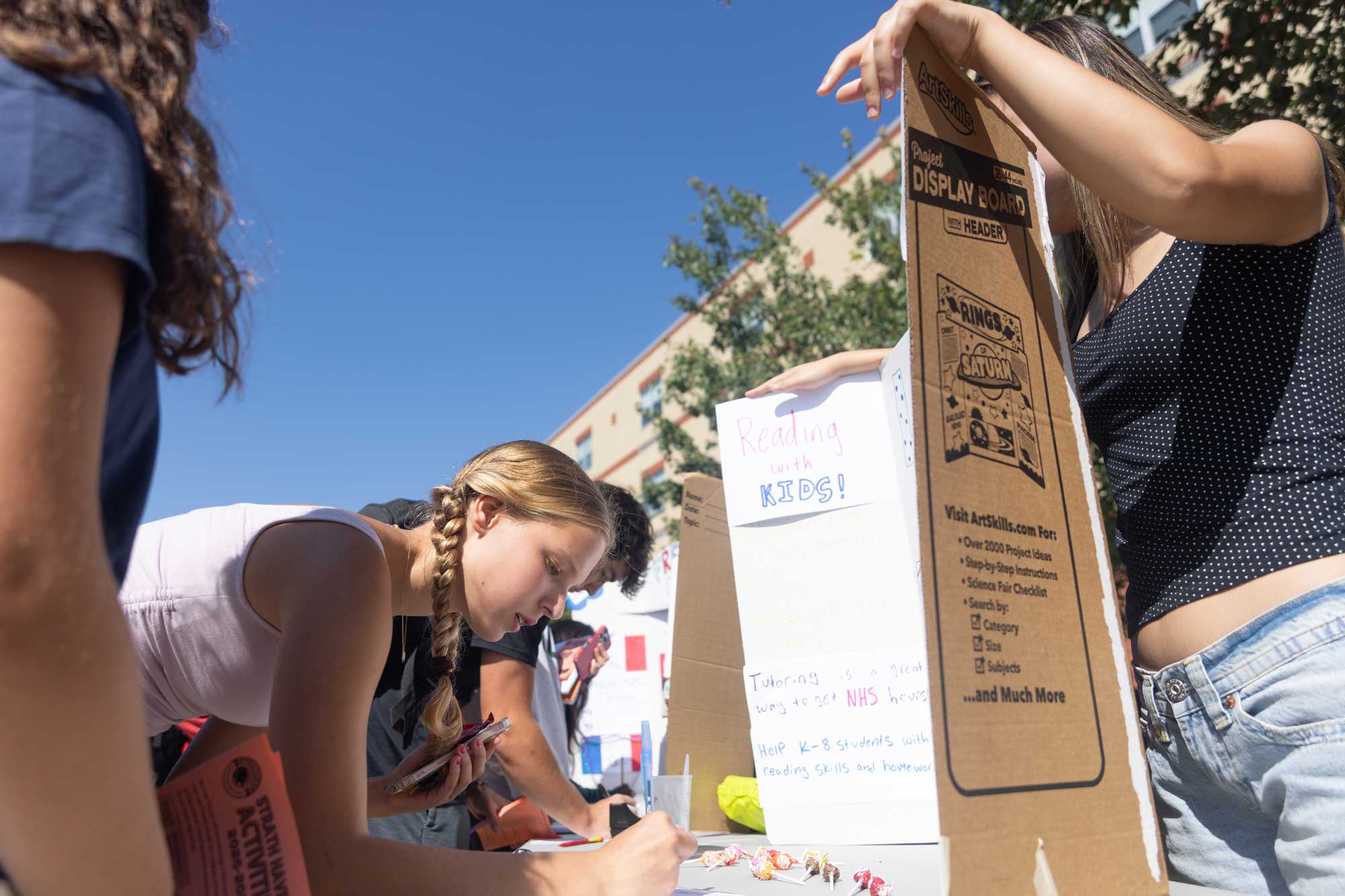 Gwen Satterthwaite (10) signs up for Leap Into Learning in the middle of the bustling courtyard during the activities fair on September 5.