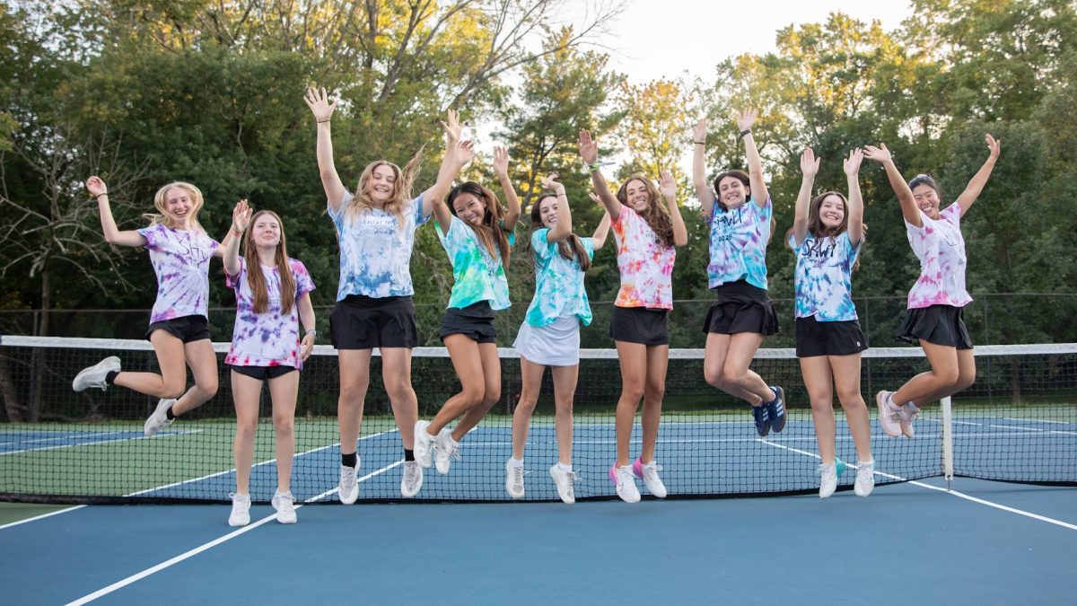 Girls varsity and junior varsity tennis seniors throw their hands in the air for their senior night on September 19. LEFT TO RIGHT: Audrey Sill, Julia Smirnova, Mia Fagone, Maisie Smith, Anna Bronchetti, Lila Martell, Mira Gold, Olivia Stransky, and Minori Saito.