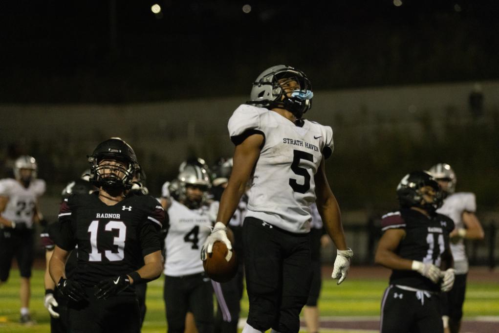 Kasey Hudson (11) jumps into the air to celebrate a big rushing gain during a game against the Radnor Raptors on September 12.