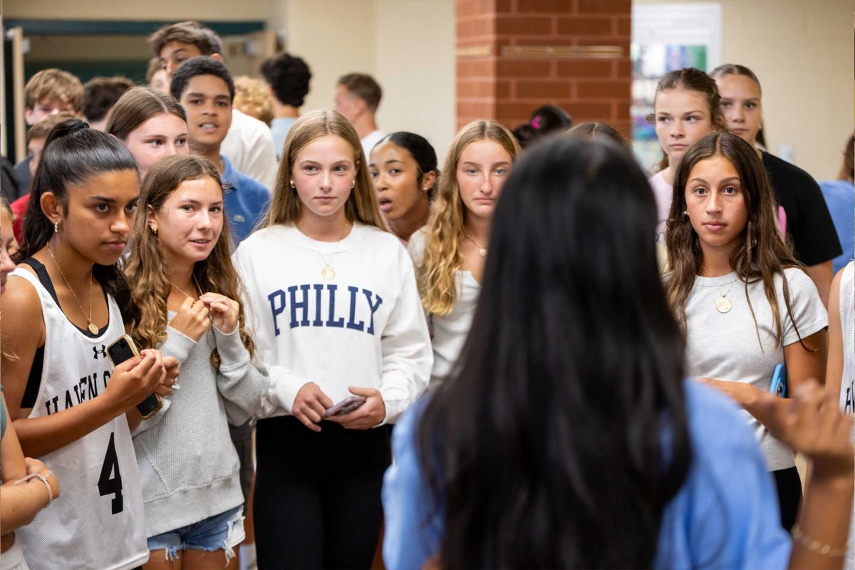 A group of incoming freshman listen to Daksha Nair (12) as she guides them though a small tour of the school at the new student orientation on Wednesday, August 20. New students had the opportunity to walk their school schedule and connect with class mates in a 'barbeque style' orientation complete with foods and desserts.