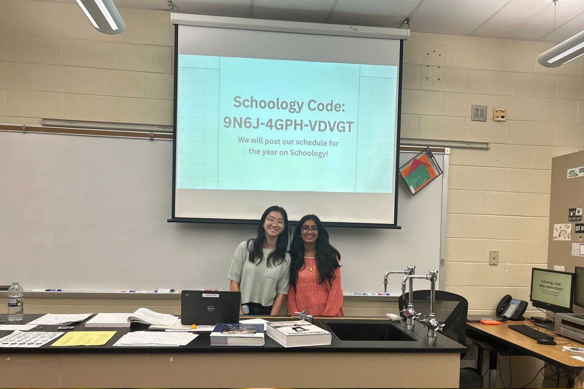 WiSTEM co-presidents Kaitlyn Ho and Lavanya Dixit smile at the club interest meeting while presenting the group's Schoology code. The meeting, which took place on September 17 in Ms. Freeman's room, introduced students to the club and their plans for the school year.