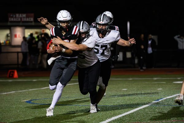 Navigation to Story: PHOTOS: Varsity football dominates in 51- point blowout