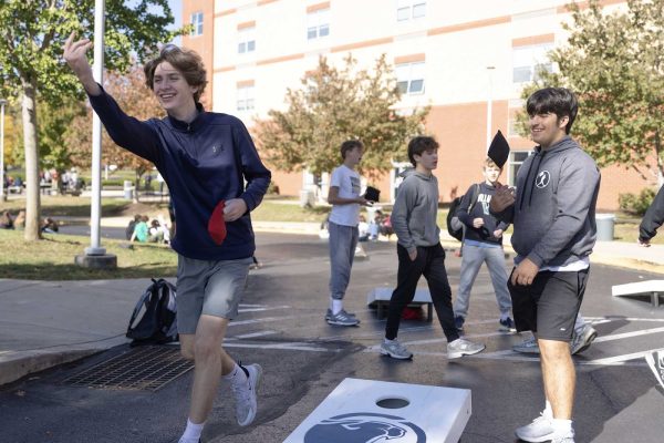 Cole Hurwitz (9) and Gavin Huffman (9) smile during a corn hole game at Wellness Wednesday. 
