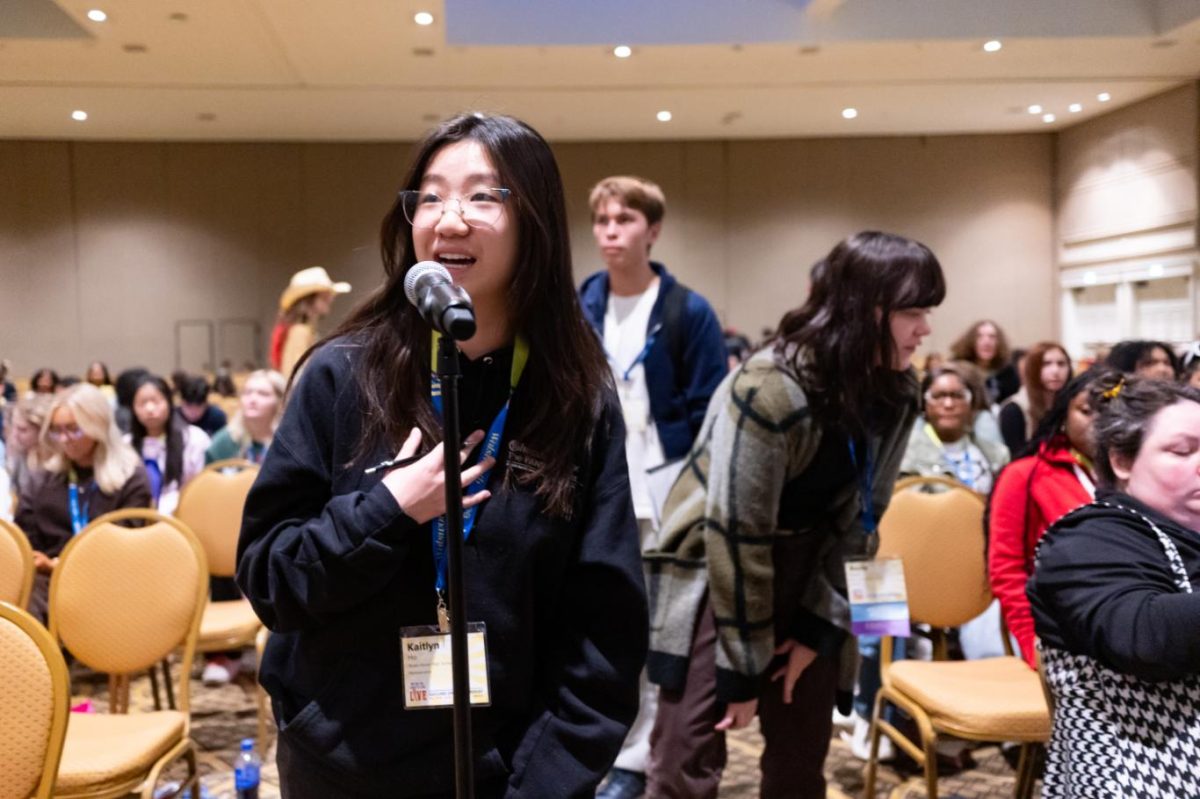 Kaitlyn Ho (12) asks a question to Pulitzer on the Road panelists after the Thursday night keynote presentation.
