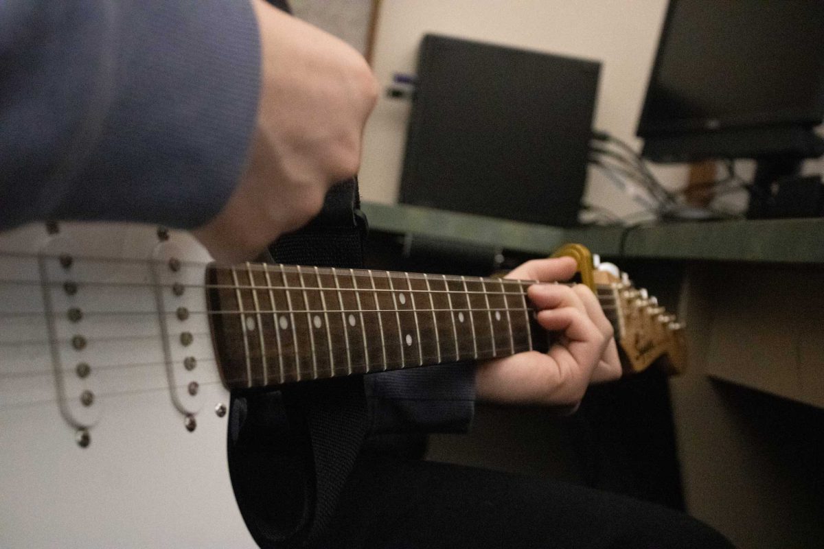 Japser Hals(12) plays his guitar to an Intro to Guitar assignment on October 13 in Room 339. Hals and all his classmates were told to play a song given by Intro to Guitar teacher Mr. Steve Fischer. "Its a lot of fun and we get to learn a lot, I can play pretty confidently and we get to practice with friends and write songs with them which is really fun," Hals said.  