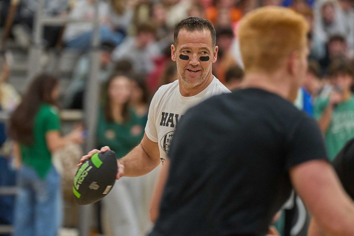Health and physical education teacher Mr. Steve Woolery looks for someone to receive his pass of the foam football during the Turkey Bowl game. The competitive final match between seniors and teachers ended with a senior victory.