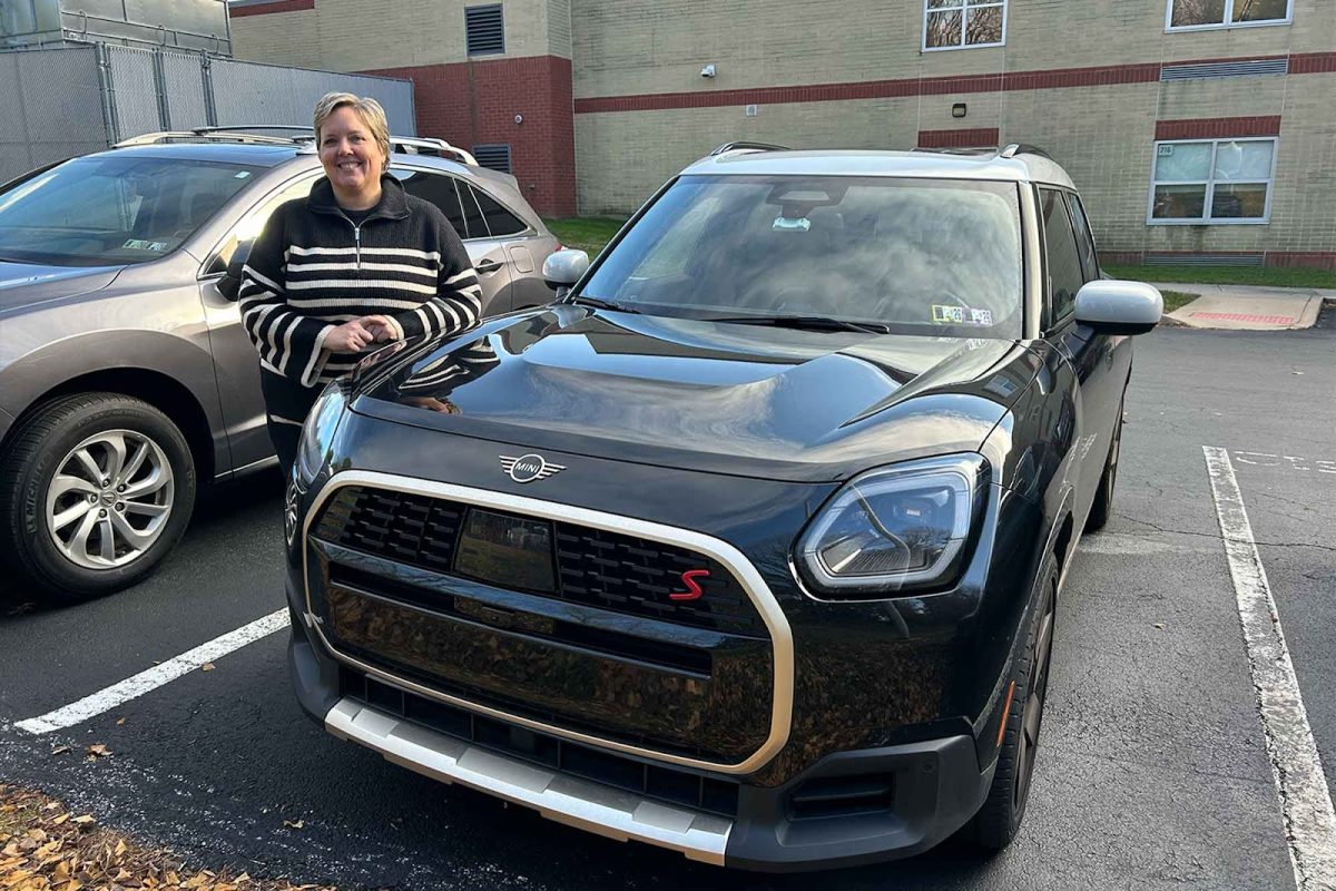 French teacher Madame Suzanne Stadnicki poses with her car, Alice. Though the Mini Cooper Countryman is Stadnicki's fourth car of the MINI brand, she aimed to switch it up a bit. “If I’m getting the same car, it’s kind of fun to mix it up with a different color,” Stadnicki said.