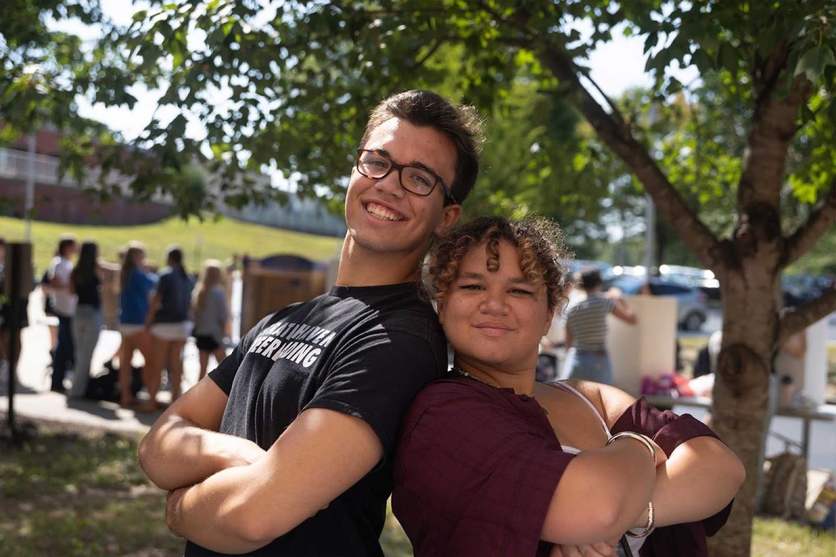 Gordon Morris (12) and Pearl Tweedy (12) stand side by side by their club booths outside the cafeteria during lunch block on September 5th. Students met outside for the annual Activities Fair where leaders promoted their clubs to the rest of the school.