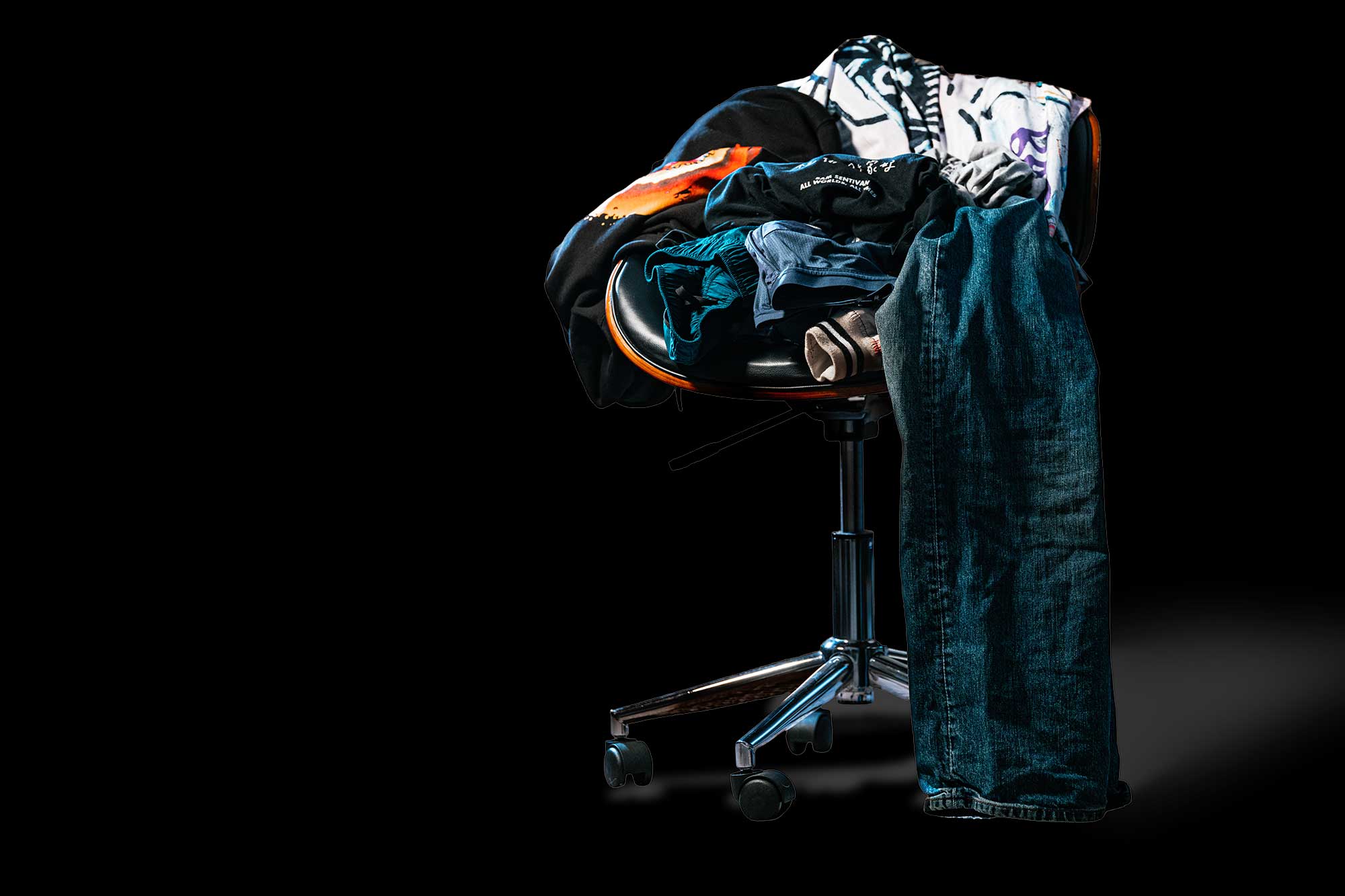 PHOTO ILLUSTRATION: Clothing piled on a chair illustrates fast fashion or overconsumption.