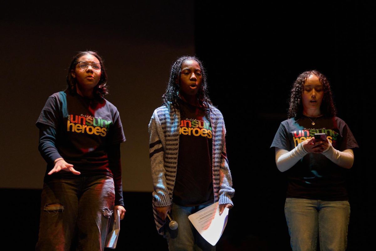 Bianca Blake (10), Daija Bradwell (11), and Kara Siri (11) perform an original slam poem during the assembly.