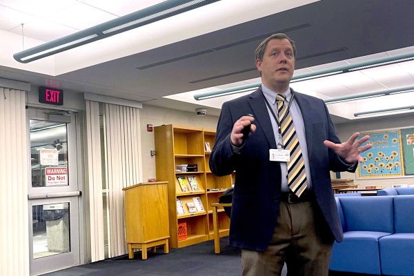 Principal Mr. Andrew Benzing presents at the February 4 community forum. The forum explored potential ways to renovate the high school as part of the district's $164 million capital plan.