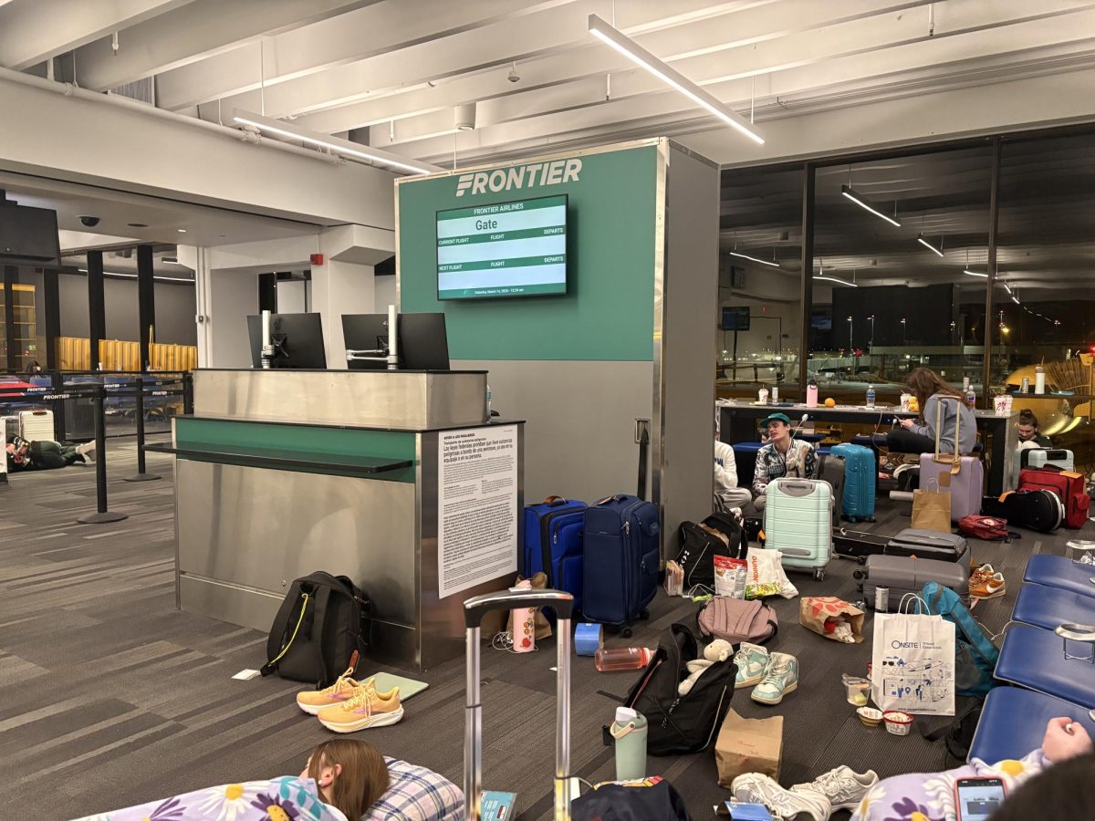 Students' bags clutter the gate in an attempt to make the space their own. Some students opened their suitcases to retrieve pajama pants and toothbrushes before they tucked themselves into quieter corners for rest.