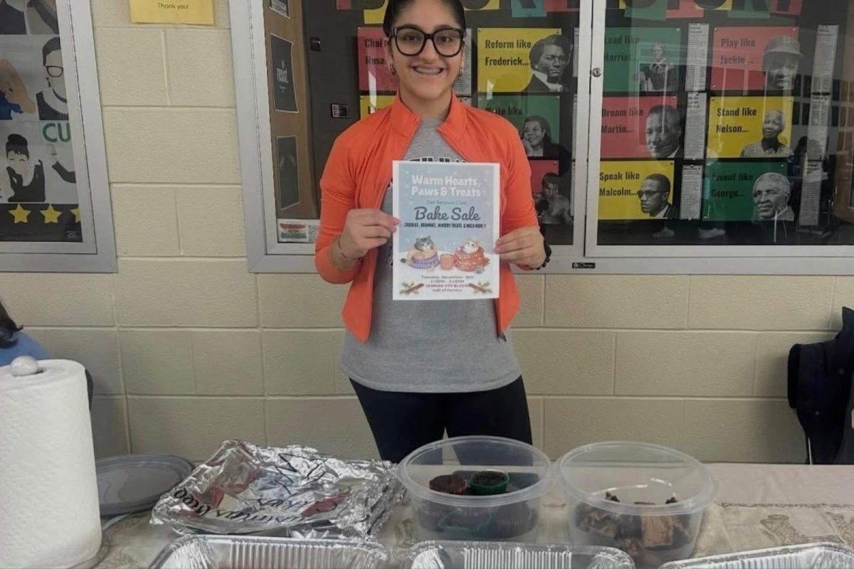 Fundraising Coordinator Kavya Bhola (10) greets Haven students at a Cat Rescue Club Bake sale. Provided by Tilly Gebhardt.