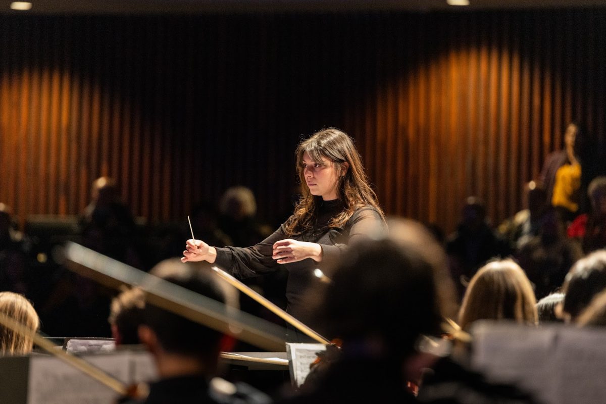 New jazz band director Ms. Camille Bachman directs a song for the orchestra during the orchestra concert on October 15, 2025.