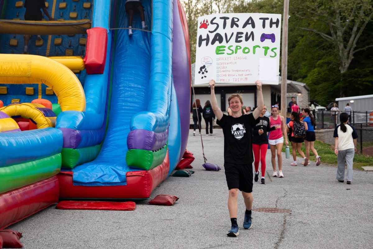 Thomas Waltman (9) promotes the ESports team at Spring Fling on Friday, April 24. Sponsored by the student council, various clubs and student organizations gathered, and set up a table to fundraise and promote their club.