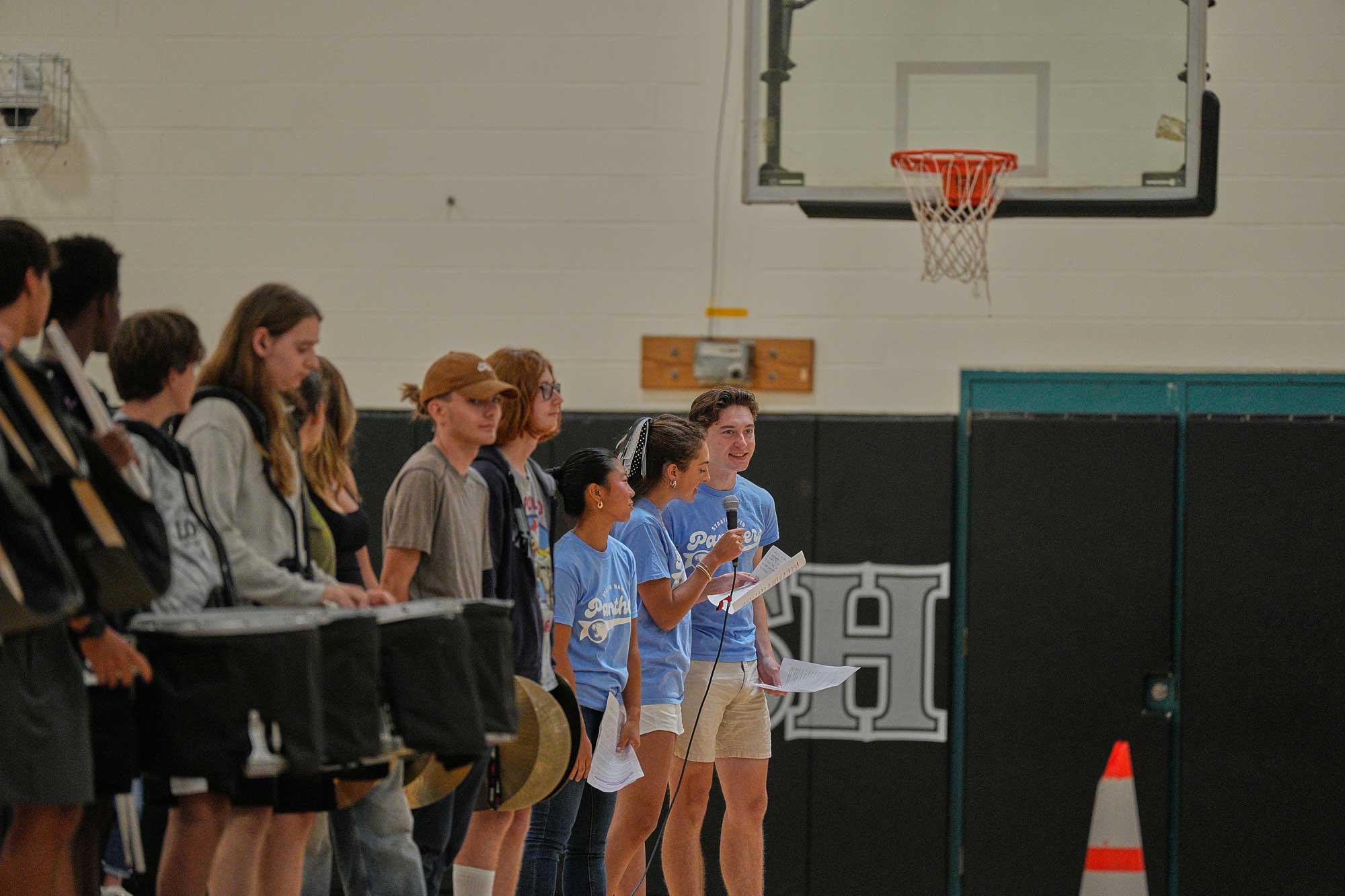 Student Council president Minori Saito (12) and vice presidents Lila Martell (12) and Casper Stockman (12) share remarks and plans for the school year during the opening of school and yearbook distribution rally on August 29.