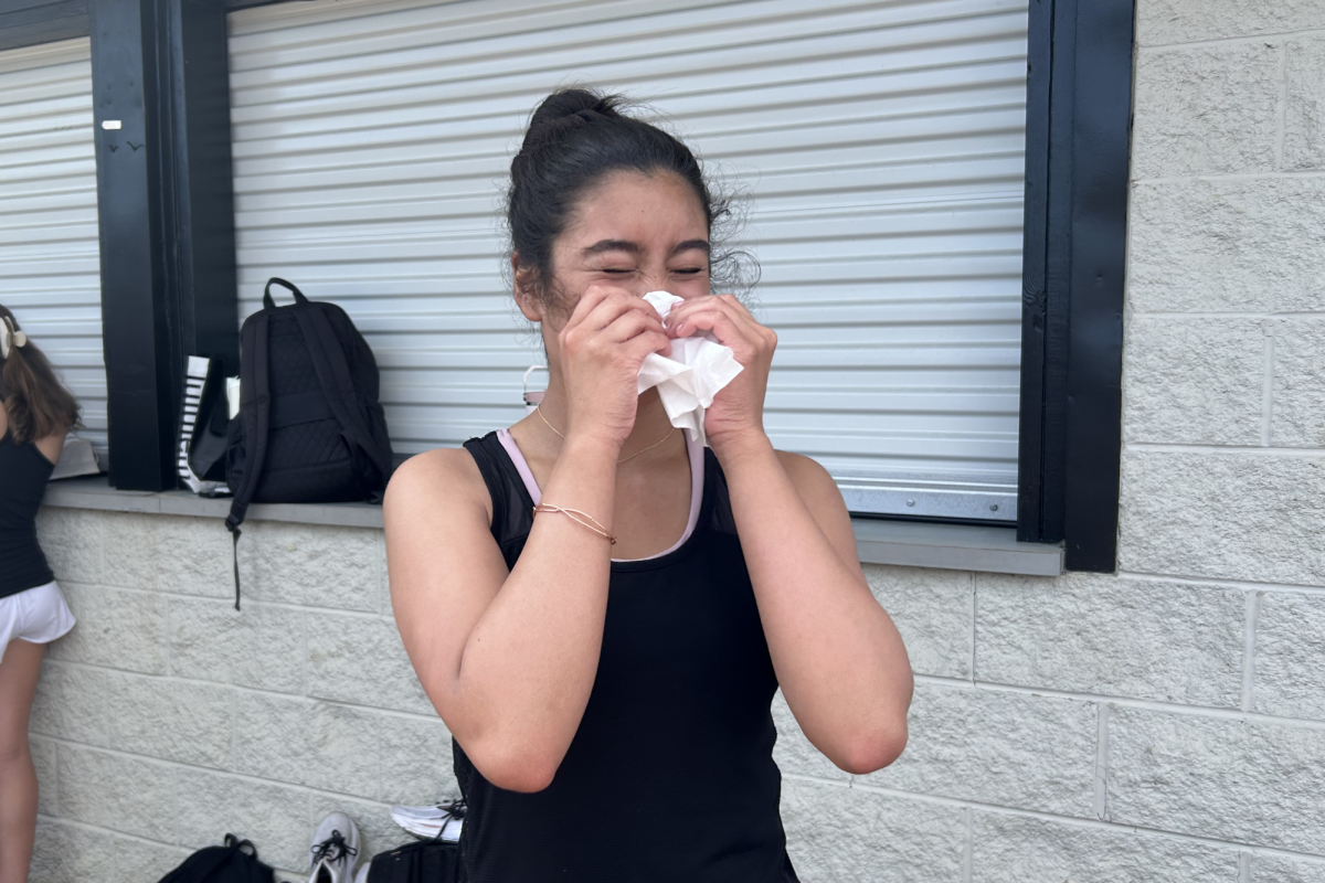 Daisy Sanchez Mejia (10) takes a break from track practice to blow her nose during spring allergy season on April 14.