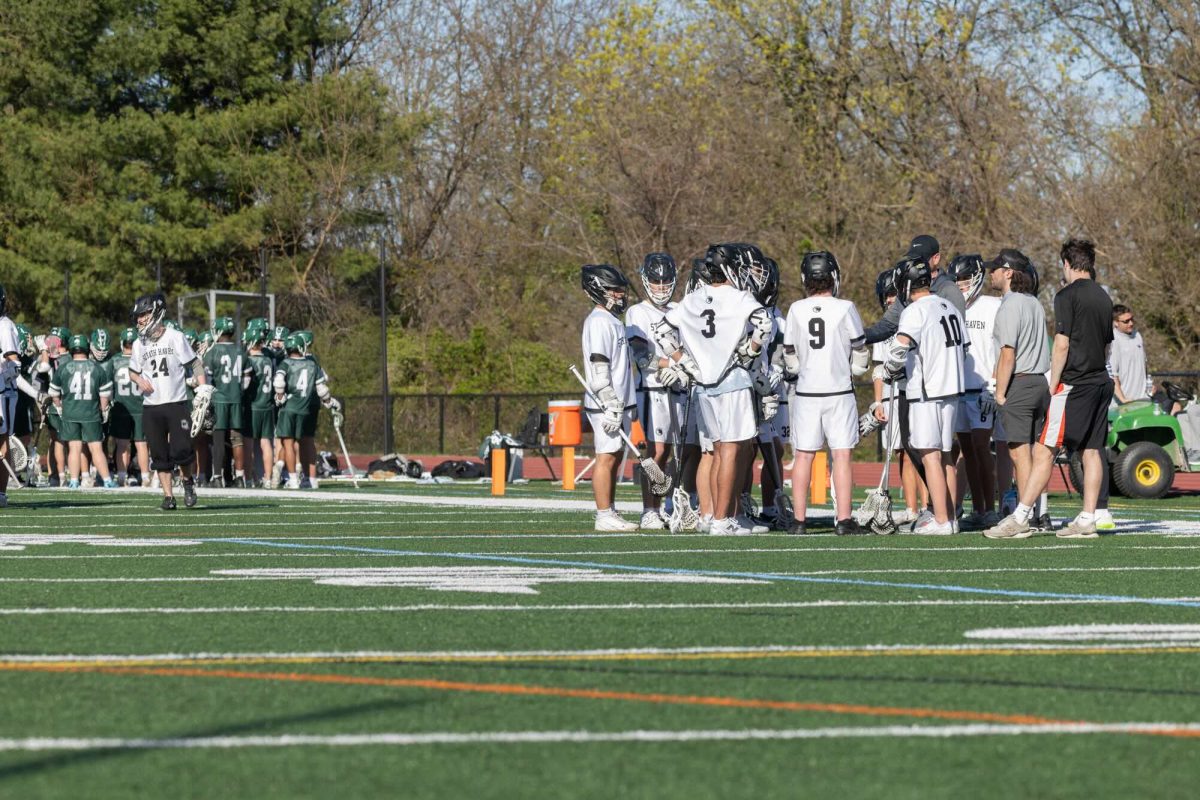 The Haven boys lacrosse team huddles to discuss their game home against Methacton on April 11. With the new PIAA rule, students can join sports teams at public schools that are not available to them at their faith-based school.