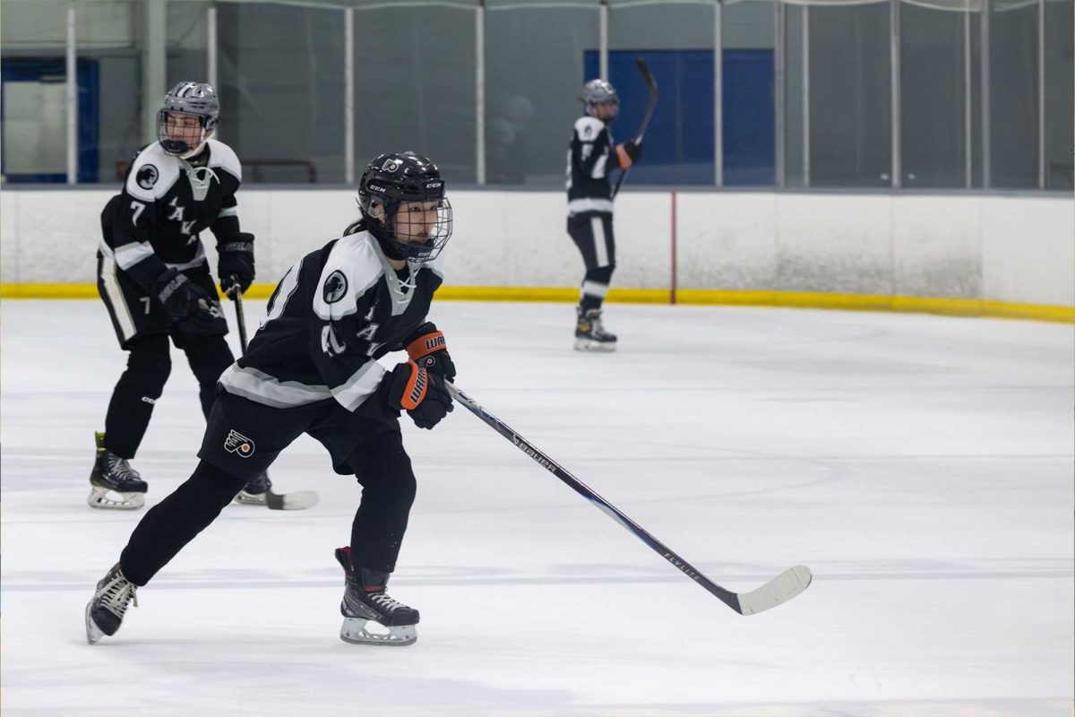 Reina Ohtani (11) focuses on the ice at the playoff game on Feb. 24. Haven lost to the number one seed, Pope John Paul II High School. 