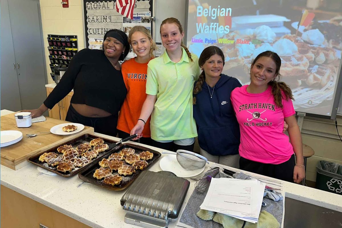 Students present their freshly made belgian waffles. Provided by Ms. Jennifer Zanoni.