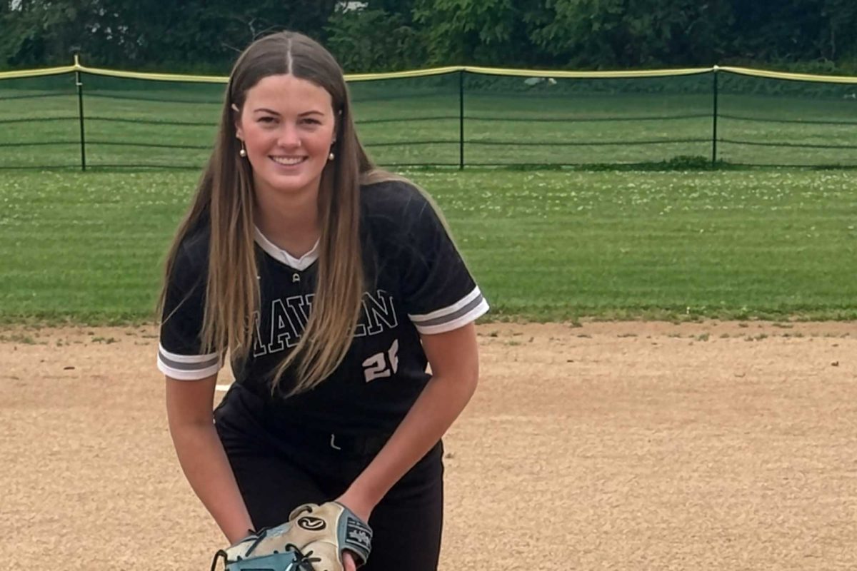 Annika Slootmaker (12) smiles from her spot on the pitcher's mound.