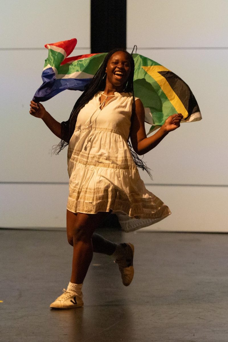 Thandiwe Jemwa (12) skips across the stage representing South Africa in the annual International Day assembly on May 1st. The fashion show segment of the performance made everyone in the audience cheer. "I think it taught me how to deal with stuff when I'm under stress and I know I can make a good product," Jemwa said.