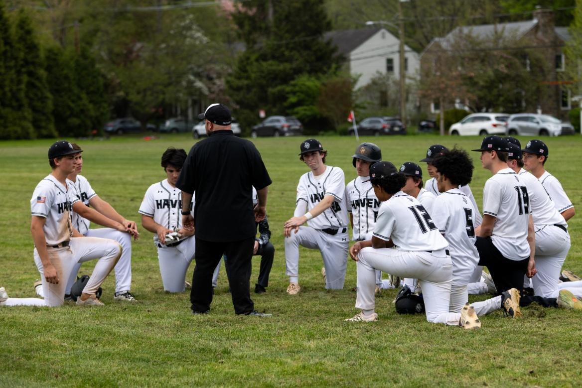 The freshman baseball team takes a knee after their win against Lower Merion on April 24 on Henderson field. The team enjoyed an undefeated season until their game on May 19 where they lost to Penncrest