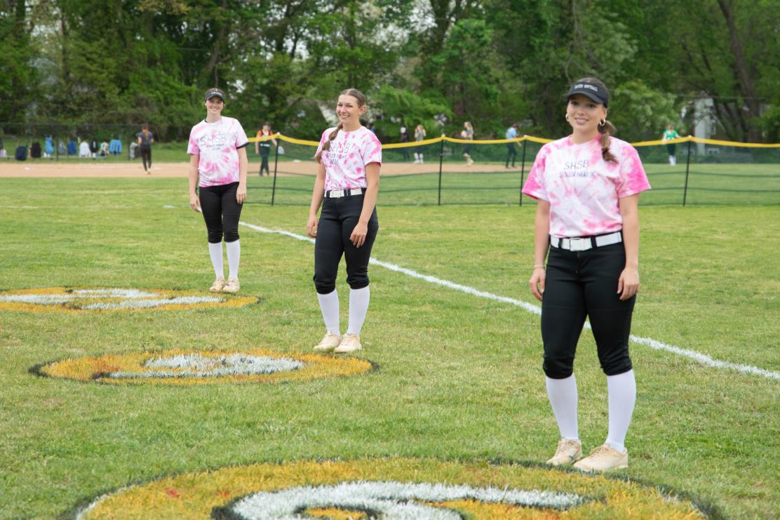 Annika Slootmaker (12), Avery Smith (12), and Charlotte Thase (12) pose behind their numbers that were spraypainted onto the field as part of their senior night celebration on April 29. The girls won against Radnor 10-0. 