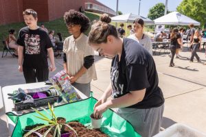 Maddison Douglas (12) gathers soil for her plant at Wellness Wednesday on May 20.