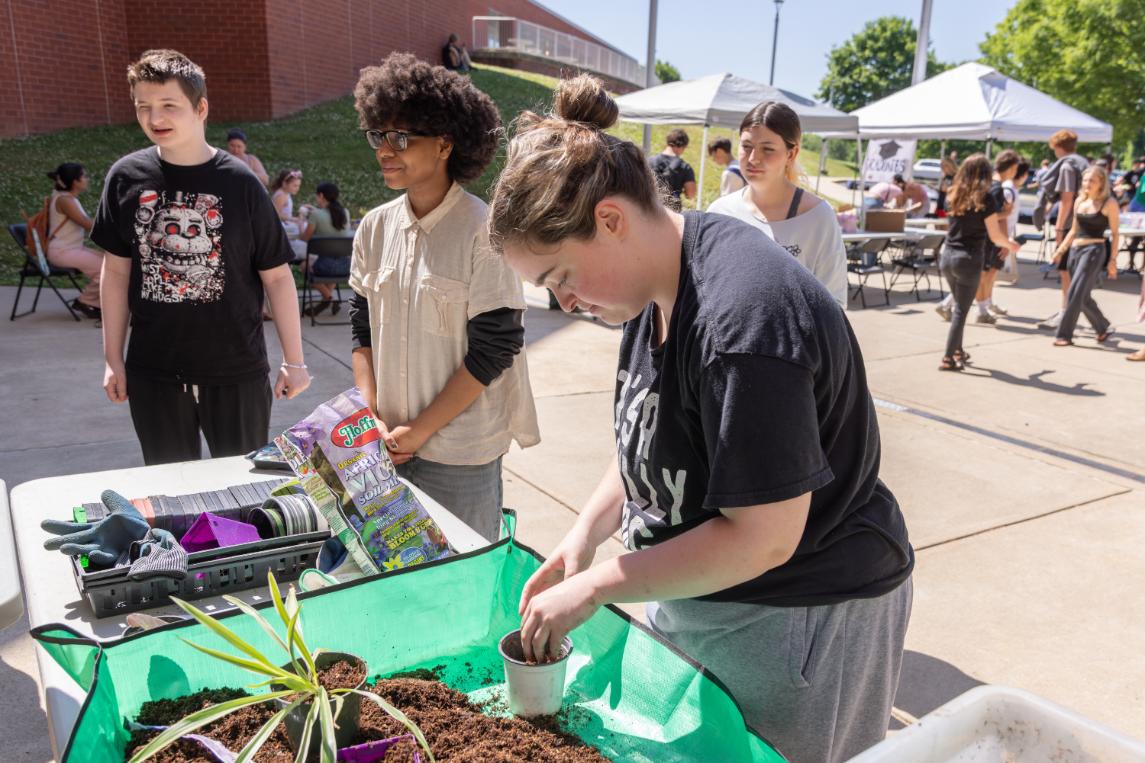 Maddison Douglas (12) gathers soil for her plant at Wellness Wednesday on May 20.