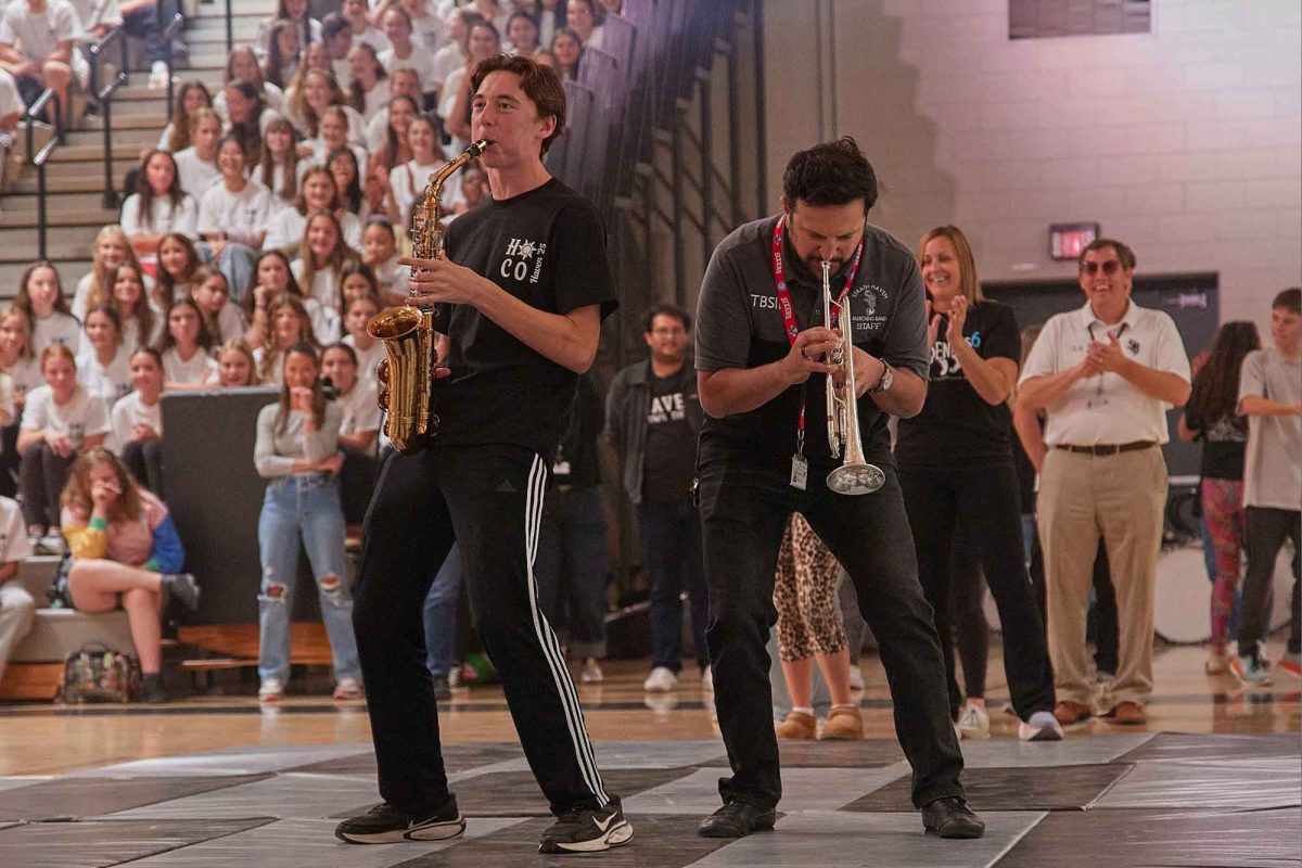 Casper Stockman (12) and music teacher Mr. Nicholas Pignataro bust out the moves during the Homecoming Pep Rally on Oct. 17.