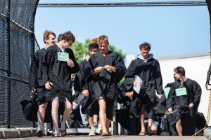 Graduates donned their graduation gowns after the final graduation rehearsal on June 4 to proceed across the bridge to the middle school. After they walked through the halls of the middle school, buses transported them to their respective elementary schools.