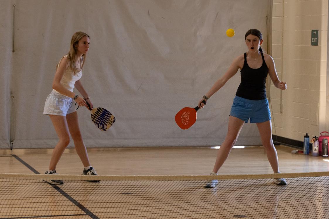 Anna Connell (11) and Laila Roe (11) take advantage of the cooler temperatures in the gym. Field Day temperatures were over 85 degrees, requiring plenty of water and breaks from the sun.