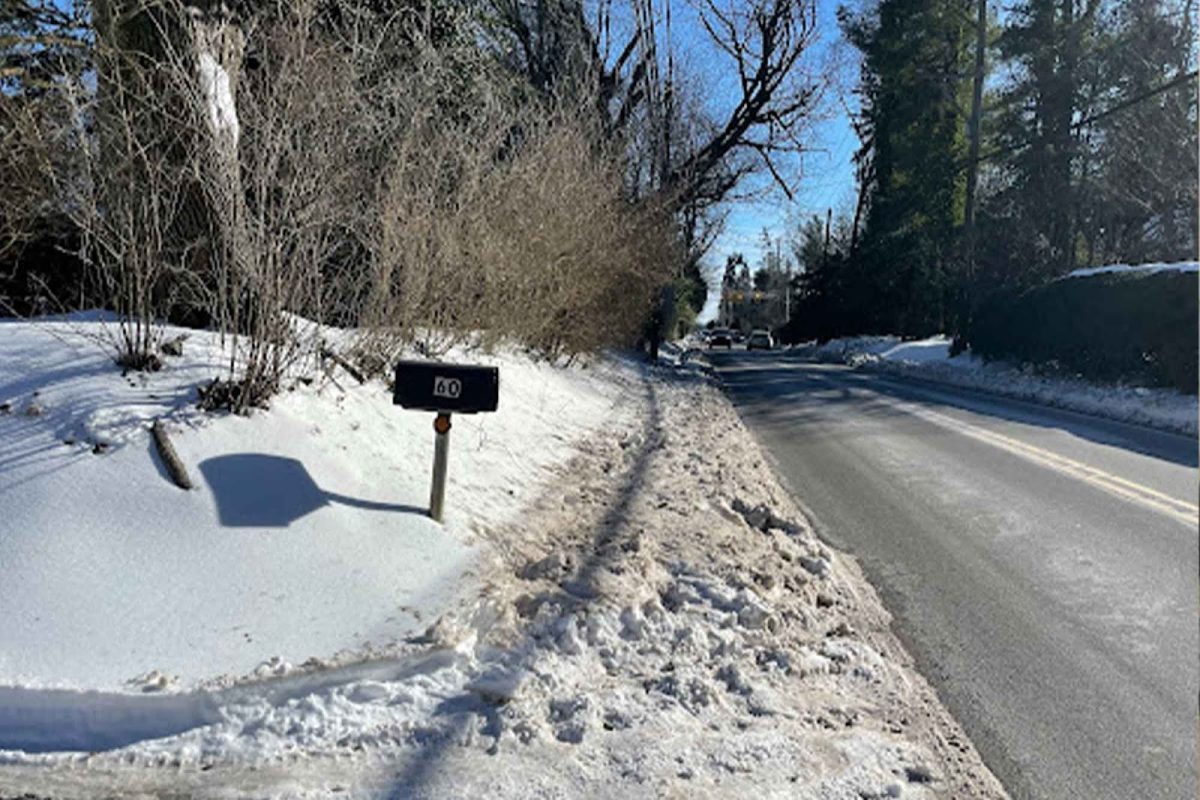 Snow covers the Providence Road sidewalk on the way to the school, making it difficult for students who walk to get to school. Multiple snowstorms over winter this year resulted in three snow days and necessitated the extension of the school year.