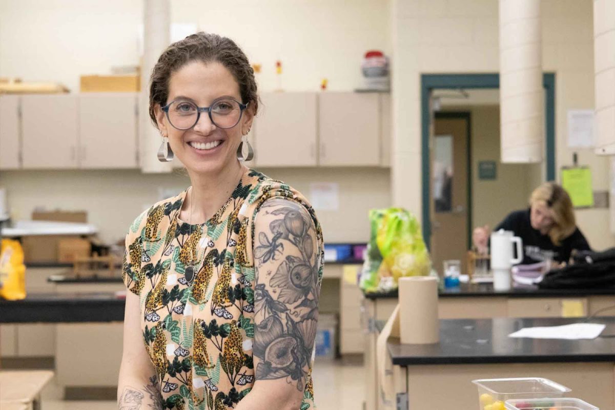 Science teacher Ms. Elisabeth Bomstein shows off one of her favorite tattoos among a growing collection of 16: a detailed fig plant and fig wasps. Bomstein has been inspired by nature and important experiences throughout her tattoo journey, with other notable pieces including floral back piece and a commemoration of past dog.